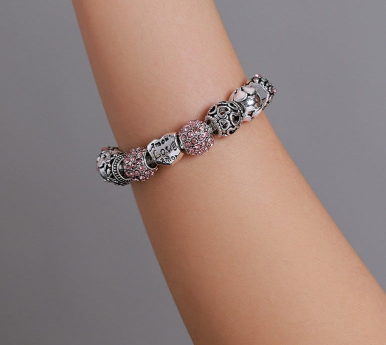 Pink Cubic Zircon Multicharm Love and Flower Charm Beads Bracelet in hand