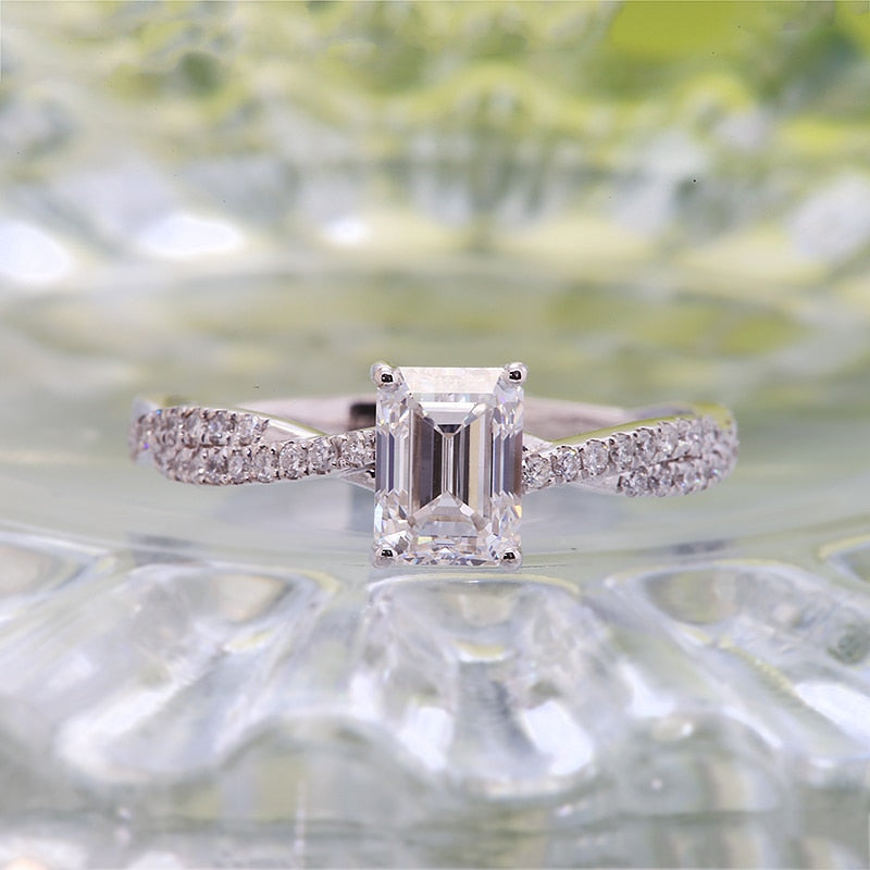 A stunning 1.12ct emerald cut lab grown diamond ring on a diamond band, crafted in 14k white gold