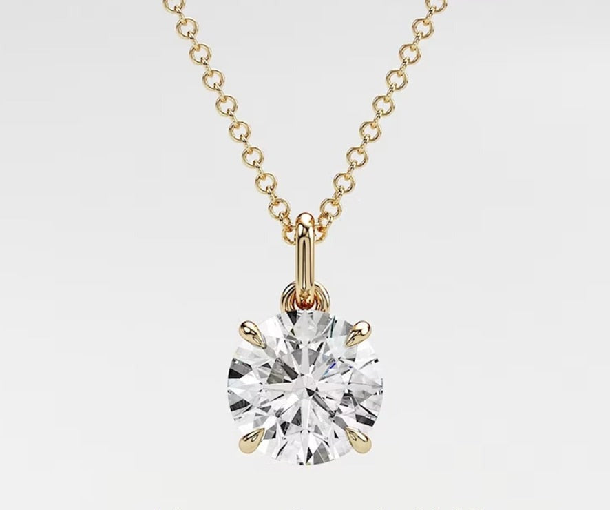A stunning gold chain necklace featuring a 1.0ct round cut lab diamond pendant, radiating elegance.